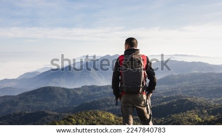 Adventurer looking at beautiful mountain landscape. Travel concept adventure active vacations outdoor