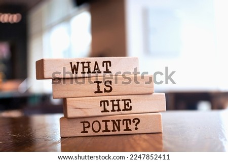 Wooden blocks with words 'What is the Point?'.