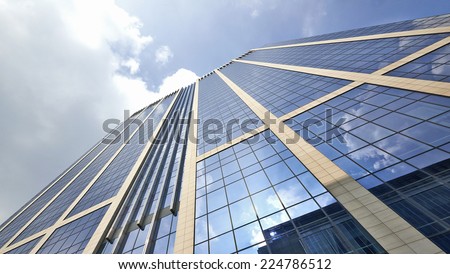 Office building with plate glass walls and gleaming steel structure.