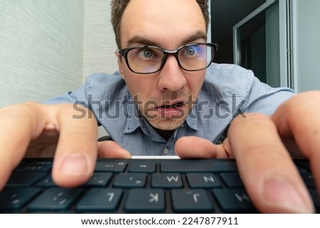 Funny and crazy man using a computer on white background. man's hands on keyboard