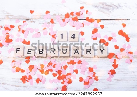 wooden letters and small hearts for Valentine's Day. 14 February background Royalty-Free Stock Photo #2247892957