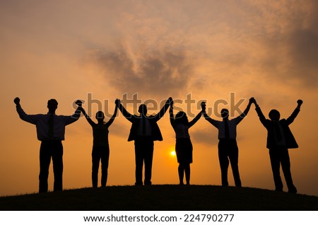 Business People Celebrating at sunset