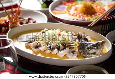 chinese steamed Giant Garoupa fish with ginger, scallions and soy sauce.  Royalty-Free Stock Photo #2247907705
