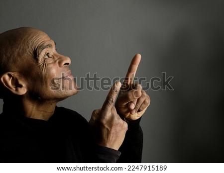 man pointing his finger up to the sky on white background with people stock photo  