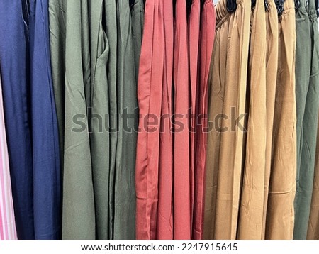 various kinds of shirts hung with a hanger. colorful collared shirts on display in the shop. The texture of the cloth is smooth and comfort to wear. shirt mockup for design. fabric color combination.
