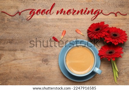 Good morning! Cup of coffee and red gerbera flowers on wooden table, flat lay. Space for text
