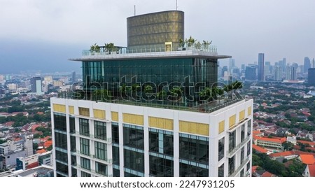 Rooftop terrace on the roof of high-rise apartment building in Jakarta. Recreation area on Roof of Skyscraper. Modern High terrace on Cityscape background.. Royalty-Free Stock Photo #2247931205