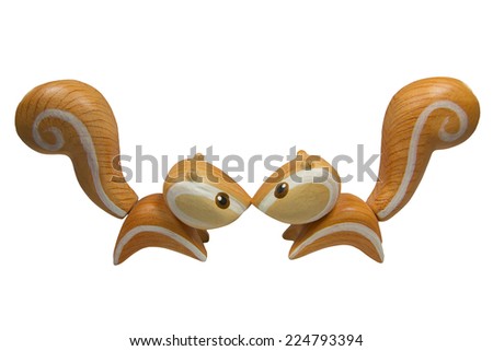 Handmade wood Twin kiss orange squirrel isolated on white background. This can use for decorate place and make background until powerpoint presentation.