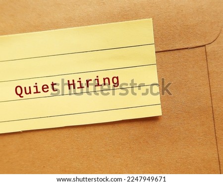 Office envelope sealed with text note QUIET HIRING - HR buzz word of recruiting strategy, employees who stand out by going above and beyond get more attention, money, praise, and more opportunities Royalty-Free Stock Photo #2247949671