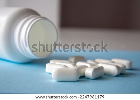 Magnesium Vitamins And Jar On a Blue Background. Blank space for the inscription on the tablet Royalty-Free Stock Photo #2247961179