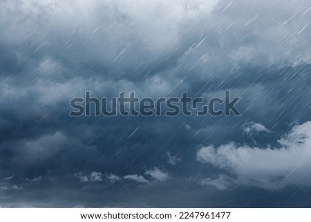 raining dark cloudy storm cloud nature in rainy season Royalty-Free Stock Photo #2247961477