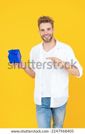 smiling man with gift on background. photo of man with gift box. man with gift isolated on white.