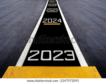 Start move forward the future to new year two thousand twenty three (2023), painted on a runway of an aircraft carrier Royalty-Free Stock Photo #2247972095