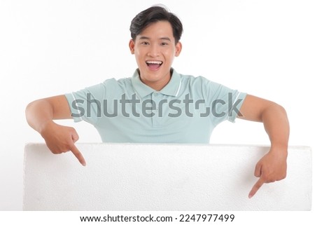 Portrait photo of a young handsome cheerful smile adult man, hold a blank empty white card with copy space to write message on, isolated on white background. Concept of promote a content.