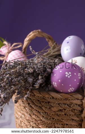 a wicker basket with Easter eggs and lavender sprigs. Easter card Provence