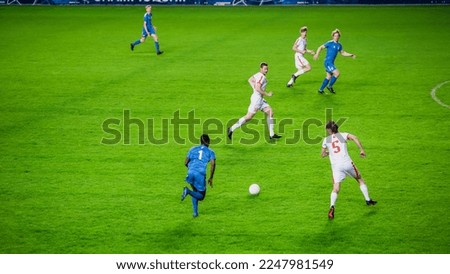 Stadium Soccer Football Match Championship: Blue Team Players Attacks, Plays in Pass. Action Game on an International Tournament Cup. Sport Channel Television Broadcast Concept. Royalty-Free Stock Photo #2247981549