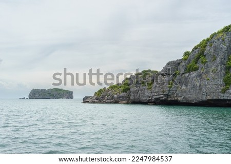 A photo of the some of the many small limestone islands around Ko Wao in Thailand. The picture was taken from a tour boat on a sailing from Ko Phangan. 
