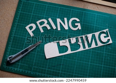 Backstage for spring lettering. Knife for cutting on mat. 