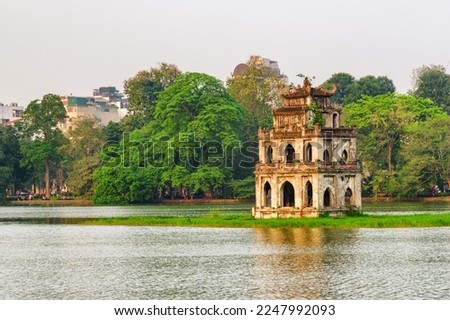 Sunset view of the Turtle Tower in middle of the Hoan Kiem Lake (Lake of the Returned Sword) at historic centre of Hanoi in Vietnam. The Turtle Tower is a popular tourist attraction of Asia.
