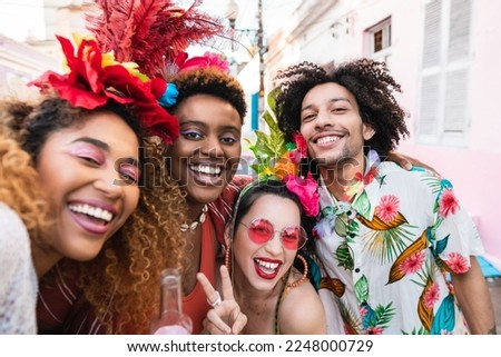 Carnival in Brazil at street party, friends in costume have fun and take selfie. Royalty-Free Stock Photo #2248000729