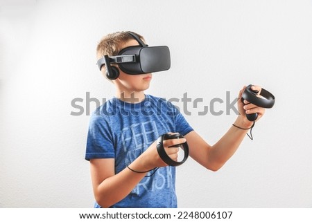 Teenager boy playing in virtual reality on whitebackground