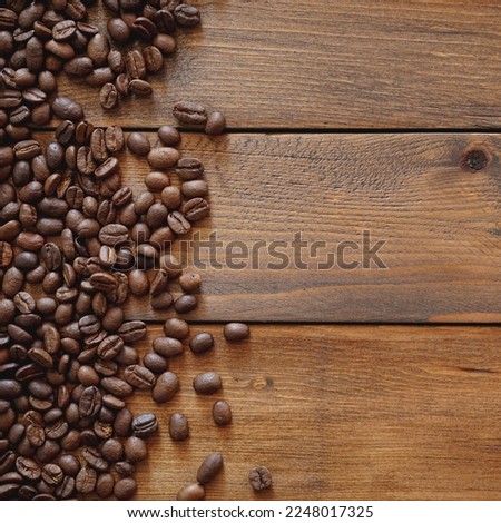 Coffee beans on brown wood background with copy space