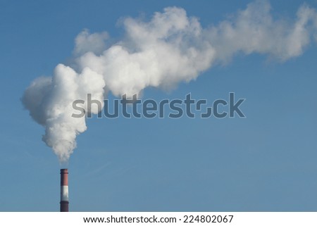 Emission of gases from the chimney at a power plant  Royalty-Free Stock Photo #224802067
