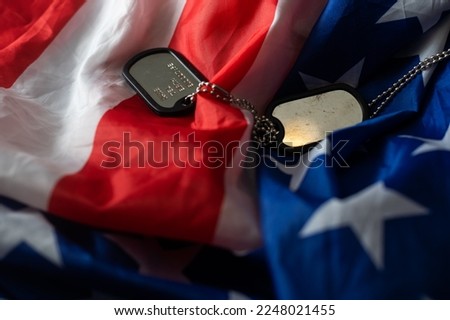 American flag and soldiers tags on background. Veterans Day Concept.