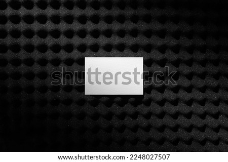 Branding business cards mockup template on a black soundproof foam background and deep shadows, real photo. Blank isolated to place your design. 