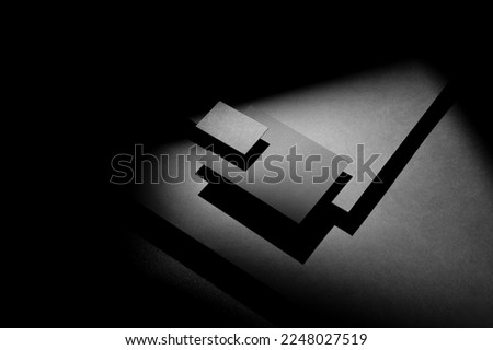 Branding A6 card and business card mockup template on a black background with deep shadows, real photo. Blank isolated to place your design. 