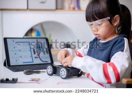 Asia students learn at home in coding robot cars and electronic board cables in STEM, STEAM, mathematics engineering science technology computer code in robotics for kids concept Royalty-Free Stock Photo #2248034721