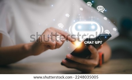 ChatGPT Chat with AI or Artificial Intelligence. woman chatting with a smart AI or artificial intelligence using an artificial intelligence chatbot developed by OpenAI. Royalty-Free Stock Photo #2248035005