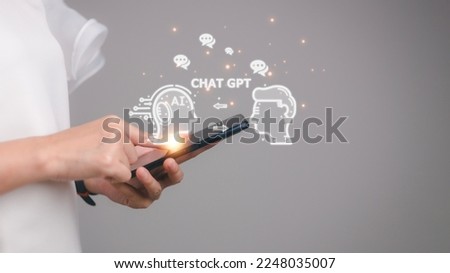 ChatGPT Chat with AI or Artificial Intelligence. woman chatting with a smart AI or artificial intelligence using an artificial intelligence chatbot developed by OpenAI. Royalty-Free Stock Photo #2248035007