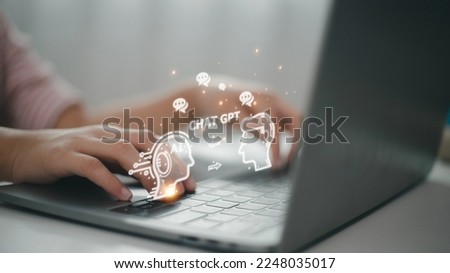 ChatGPT Chat with AI or Artificial Intelligence. woman chatting with a smart AI or artificial intelligence using an artificial intelligence chatbot developed by OpenAI. Royalty-Free Stock Photo #2248035017