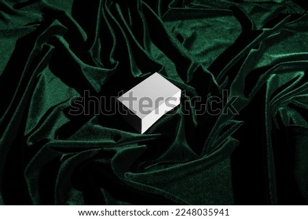 Blank business cards mockup template on a green silk fabric, real photo. Isolated surface to place your design. 