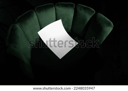Blank poster, A format letter mockup template on a velvet, green art deco furniture. Real photo, isolated surface to place your design. 