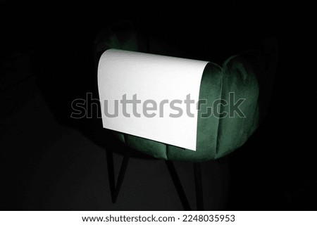 Blank poster mockup template on a velvet, green art deco furniture. Real photo, isolated surface to place your design. 