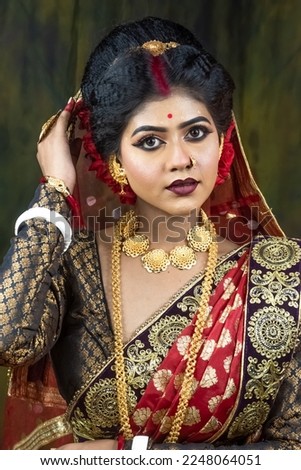 Fashion and make-up concept. Close-up portrait of an attractive young woman with creative makeup as Indian bride.