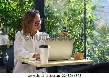 Successful Online Payment on Laptop by Young caucasian Woman, Cafe. High quality photo