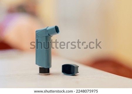 Inhalator open cap on a wood surface - Shallow focus