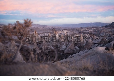 Stunning view of some rock formations in the Red  Rose Valley in Cappadocia during a beautiful sunrise. Goreme, central Anatolia, Turkey