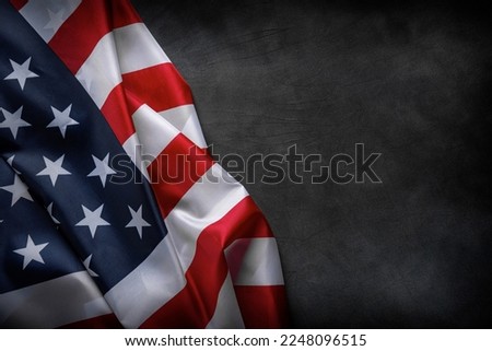 USA American flag on worn darck background. Image suitable for Patriotic concept, USA Memorial day, Labor day, 4th of July or Veteran's day celebration. Royalty-Free Stock Photo #2248096515