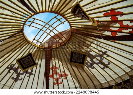 Shanyrak with Kazakh national ornament, bottom view from Kazakh yurt, symbol of Kazakhstan. Royalty-Free Stock Photo #2248098445