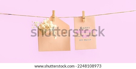 Creative greeting card for International Women's Day on lilac background Royalty-Free Stock Photo #2248108973