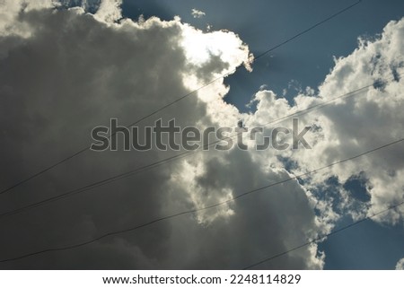 Clouds in sky. Celestial landscape. Thin wires against cloudy sky.