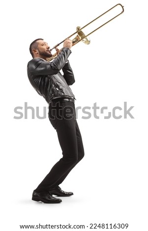 Full length side shot of a male musician playing a trombone isolated on white background Royalty-Free Stock Photo #2248116309