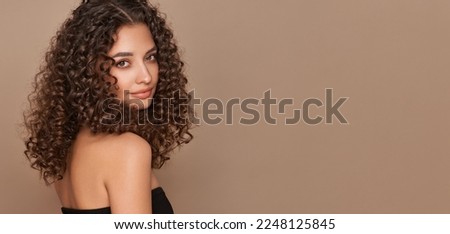 Fashion studio portrait of beautiful smiling woman with afro curls hairstyle. Fashion and beauty Royalty-Free Stock Photo #2248125845