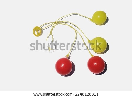 The Lato Lato toy that is played by many children in Indonesia, namely by bouncing and hitting the ball and swinging their hands. white background.




