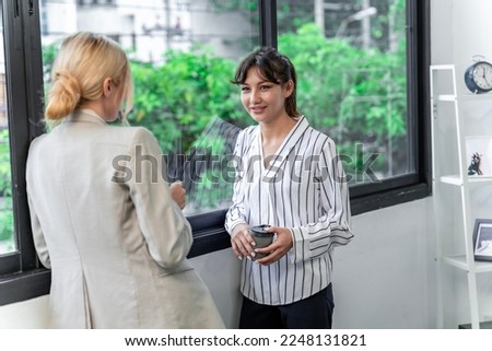 Businesswoman working at the company talking to colleagues, teamwork.