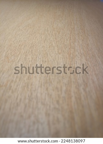 The background image is a brown, beige wooden floor, blurring the surroundings.
